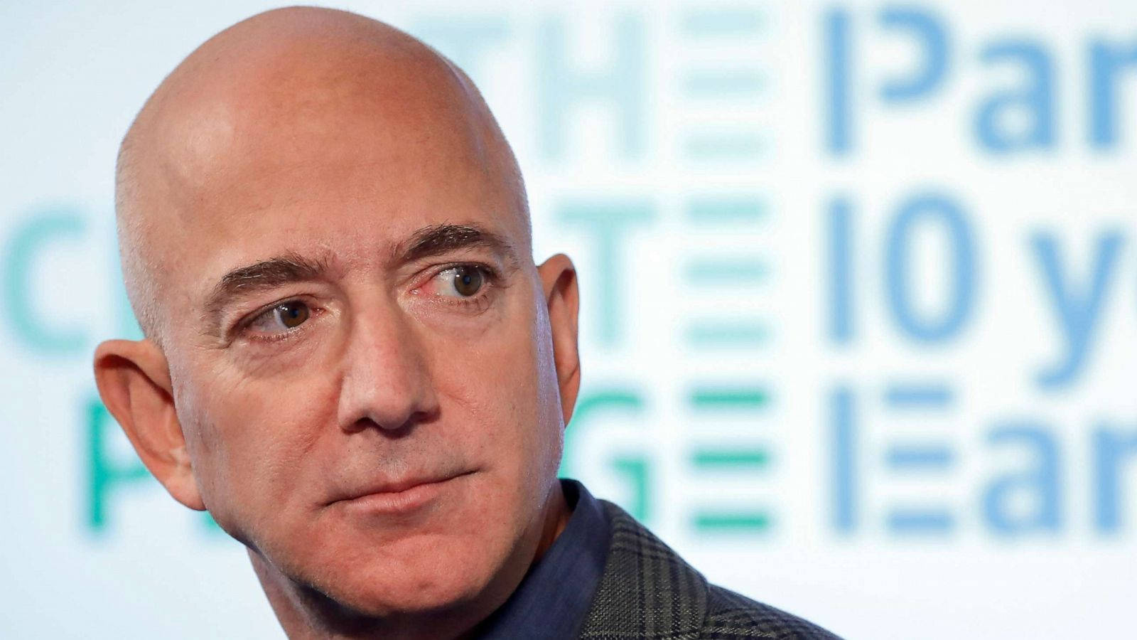 Jeff Bezos Against Text Background Background