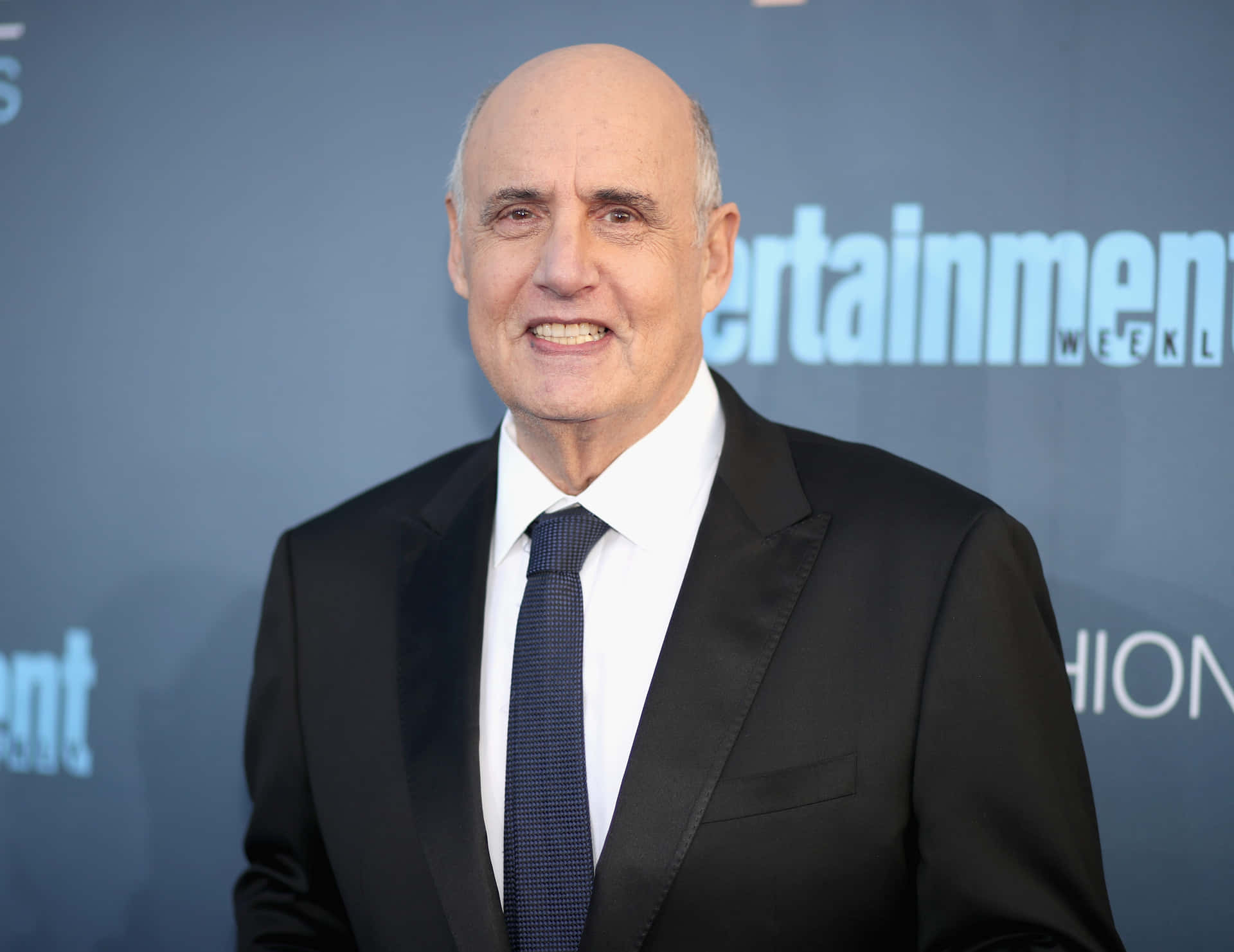 Jeffrey Tambor Posing At A Red-outfit Background