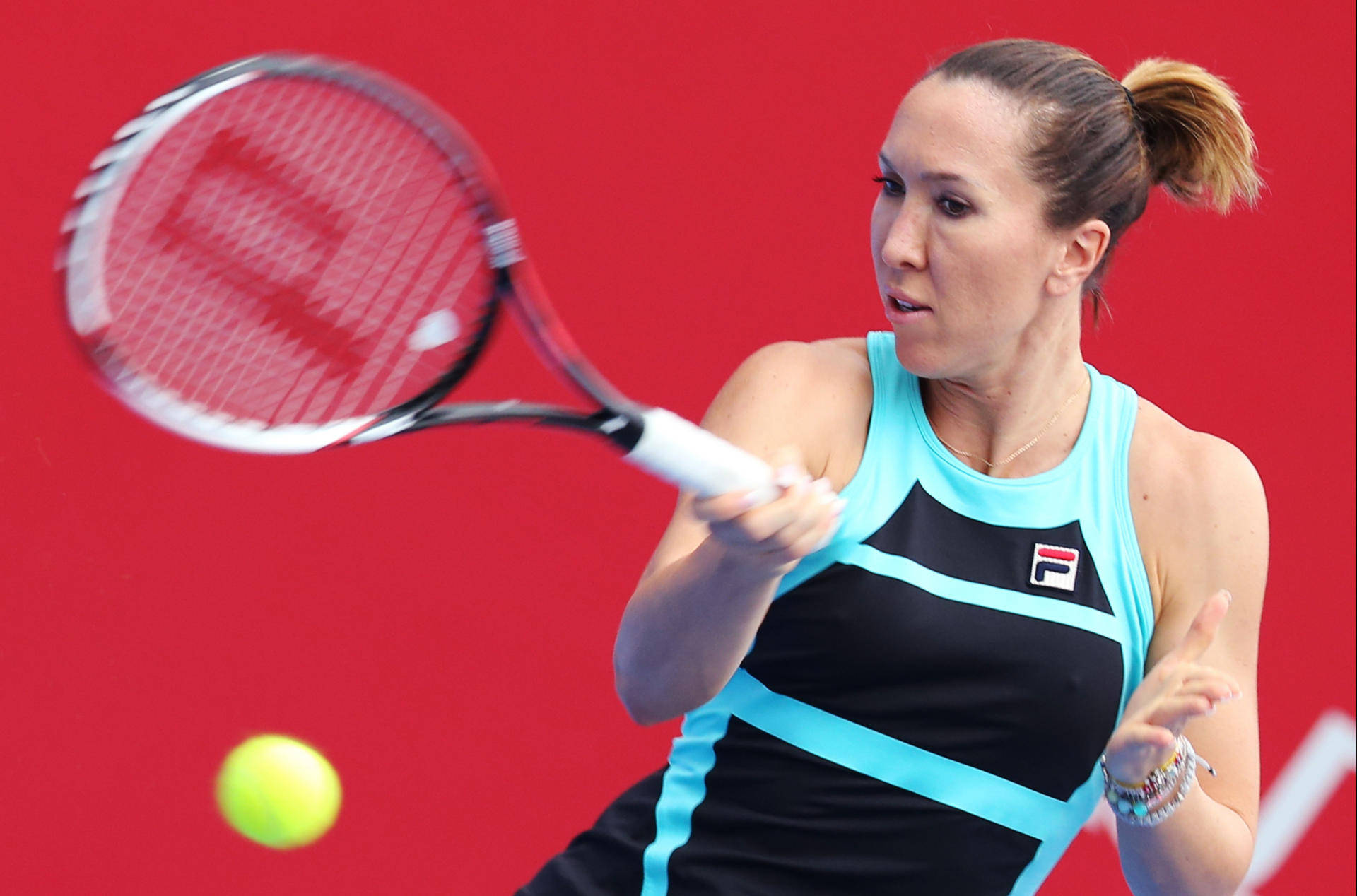 Jelena Jankovic Executing A Powerful Forehand Stroke In A Tennis Match. Background