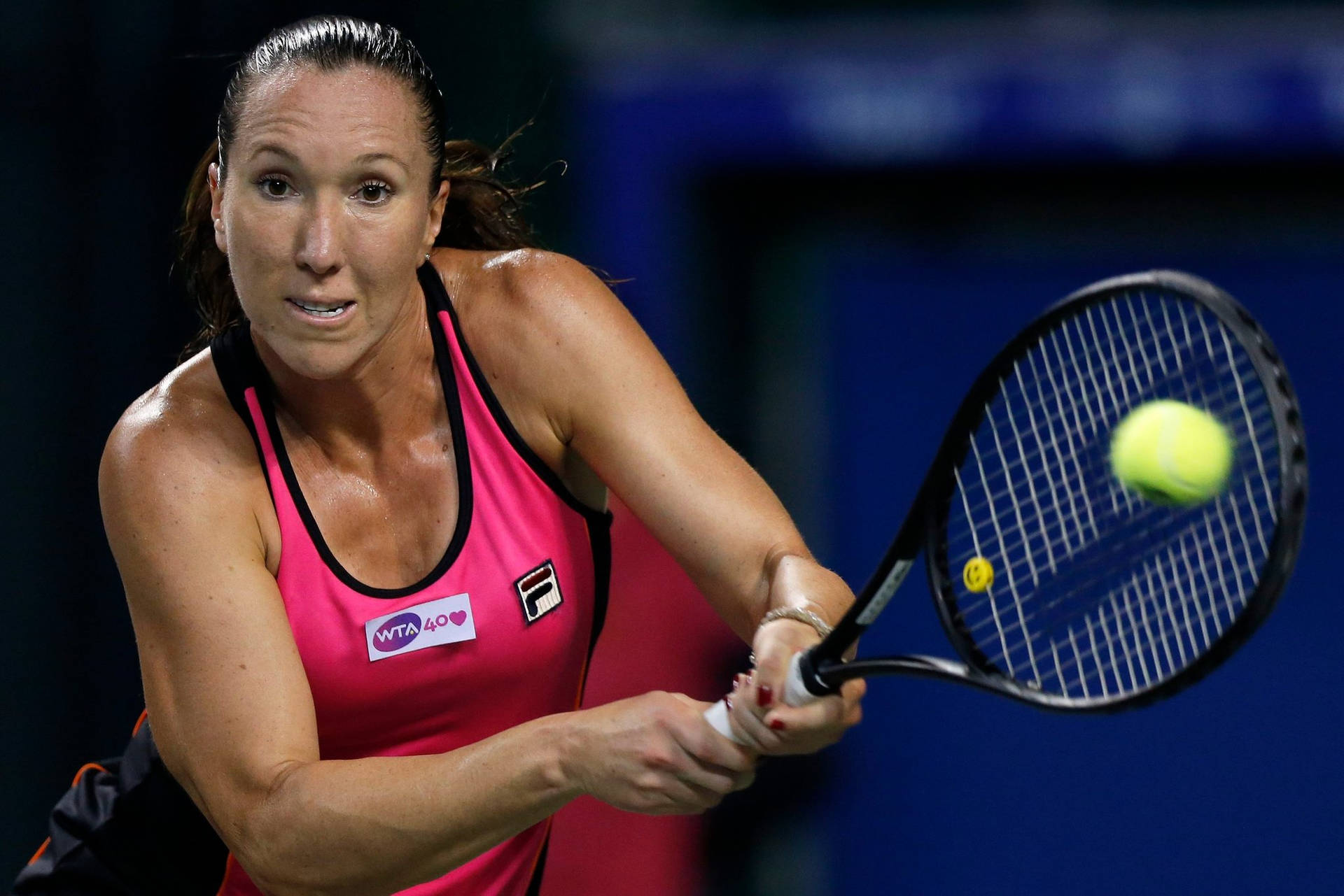 Jelena Jankovic Performing A Double-handed Stroke In A Tennis Match Background