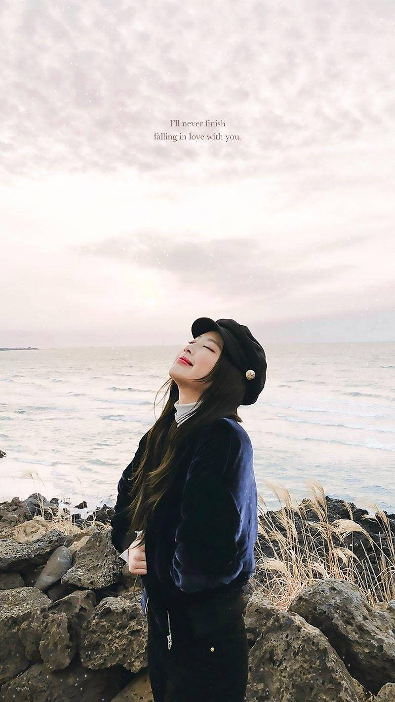 Jennie Kim On A Rocky Shore Background