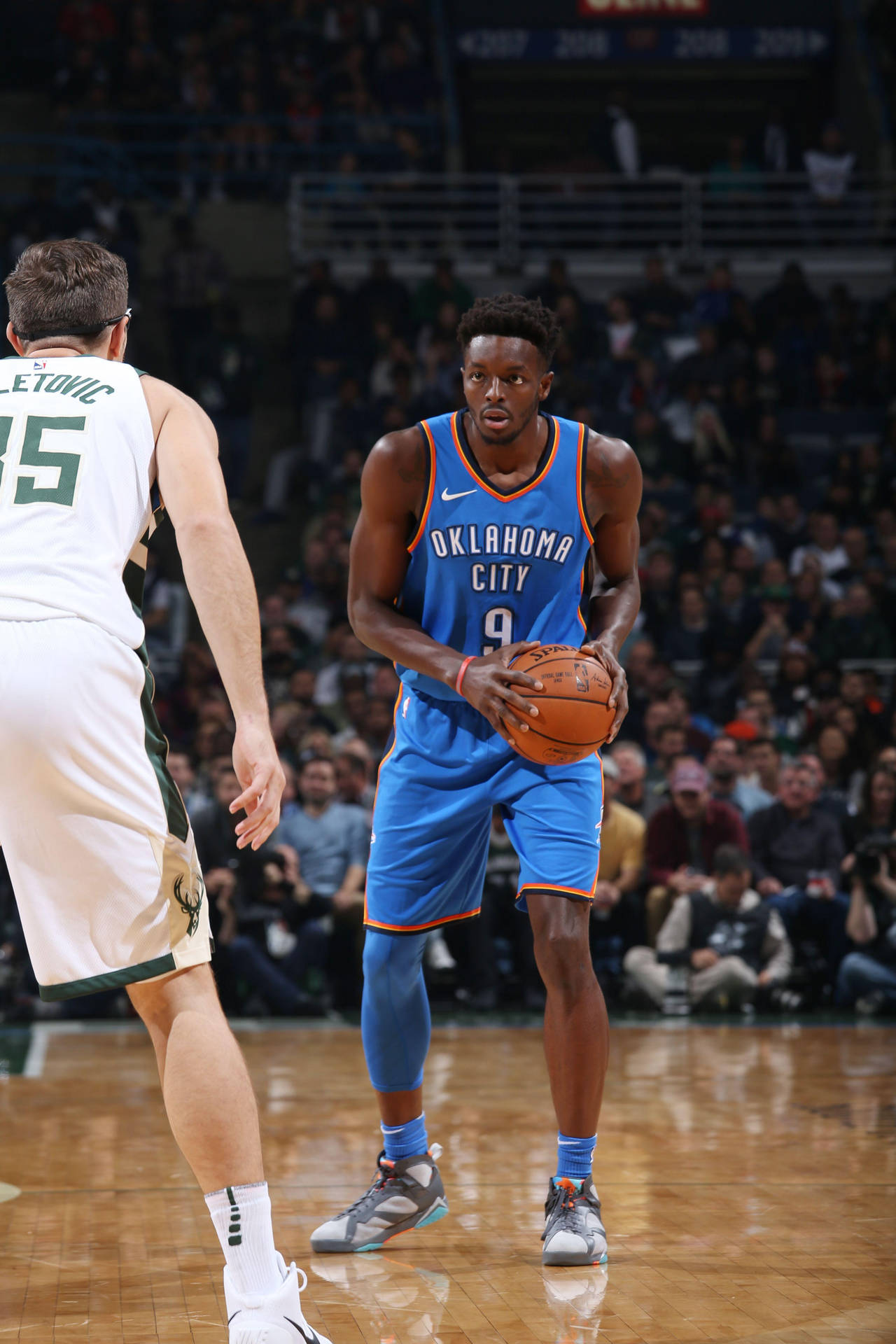 Jerami Grant Holding A Ball Background