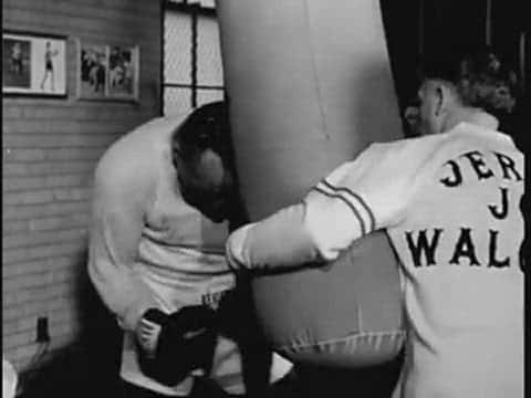 Jersey Joe Walcott Leans On A Punching Bag