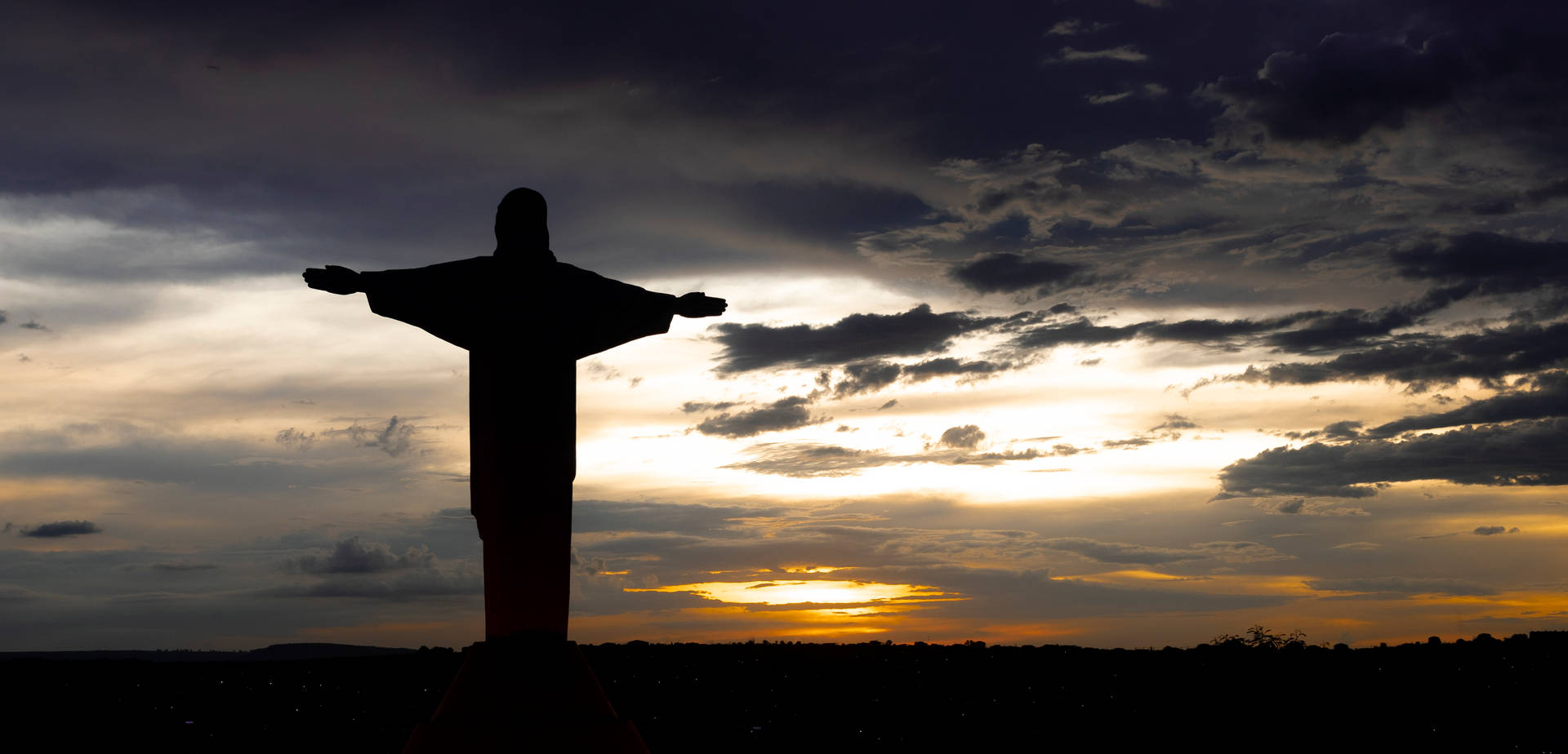 Jesus On Cross Silhouette Overlooking Sky Background