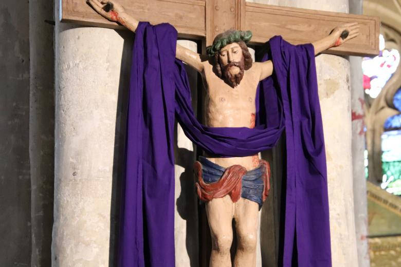 Jesus On Cross Statue With Purple Cloth Background