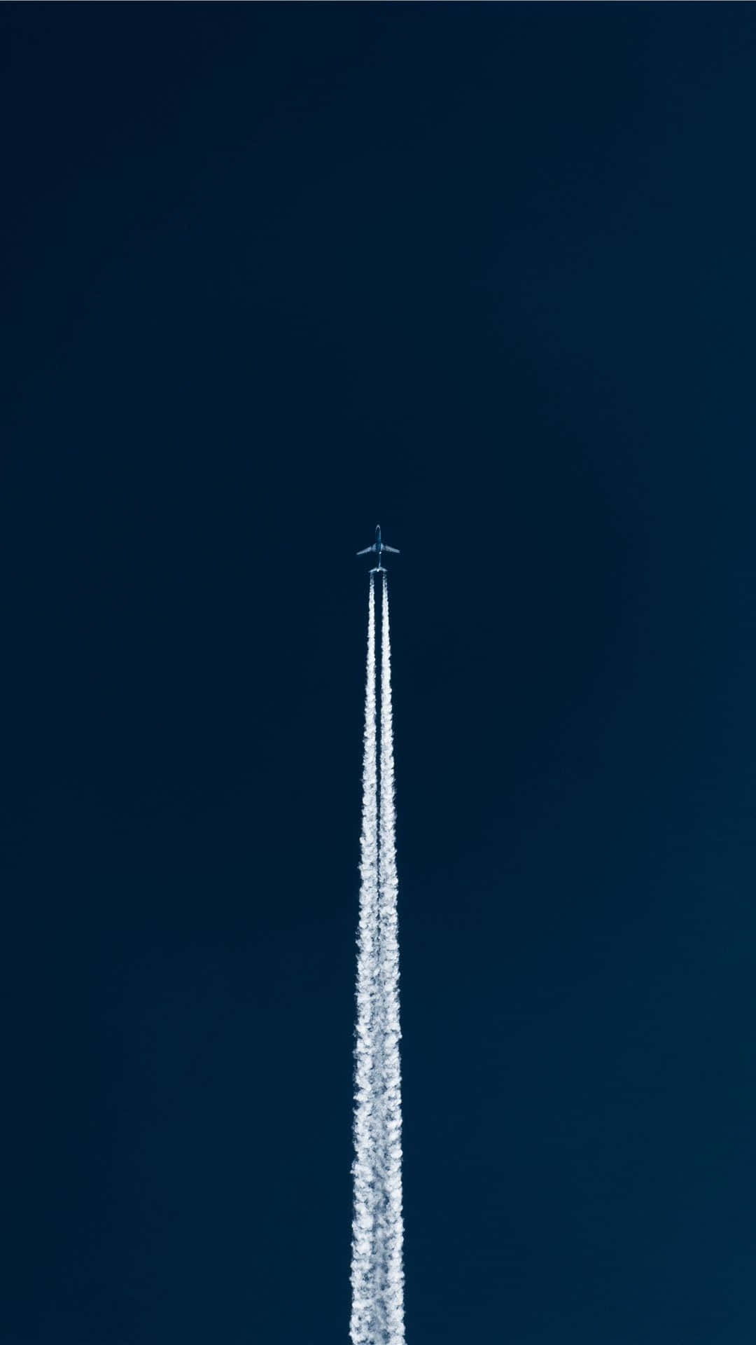 Jet Contrail Against Blue Sky Background
