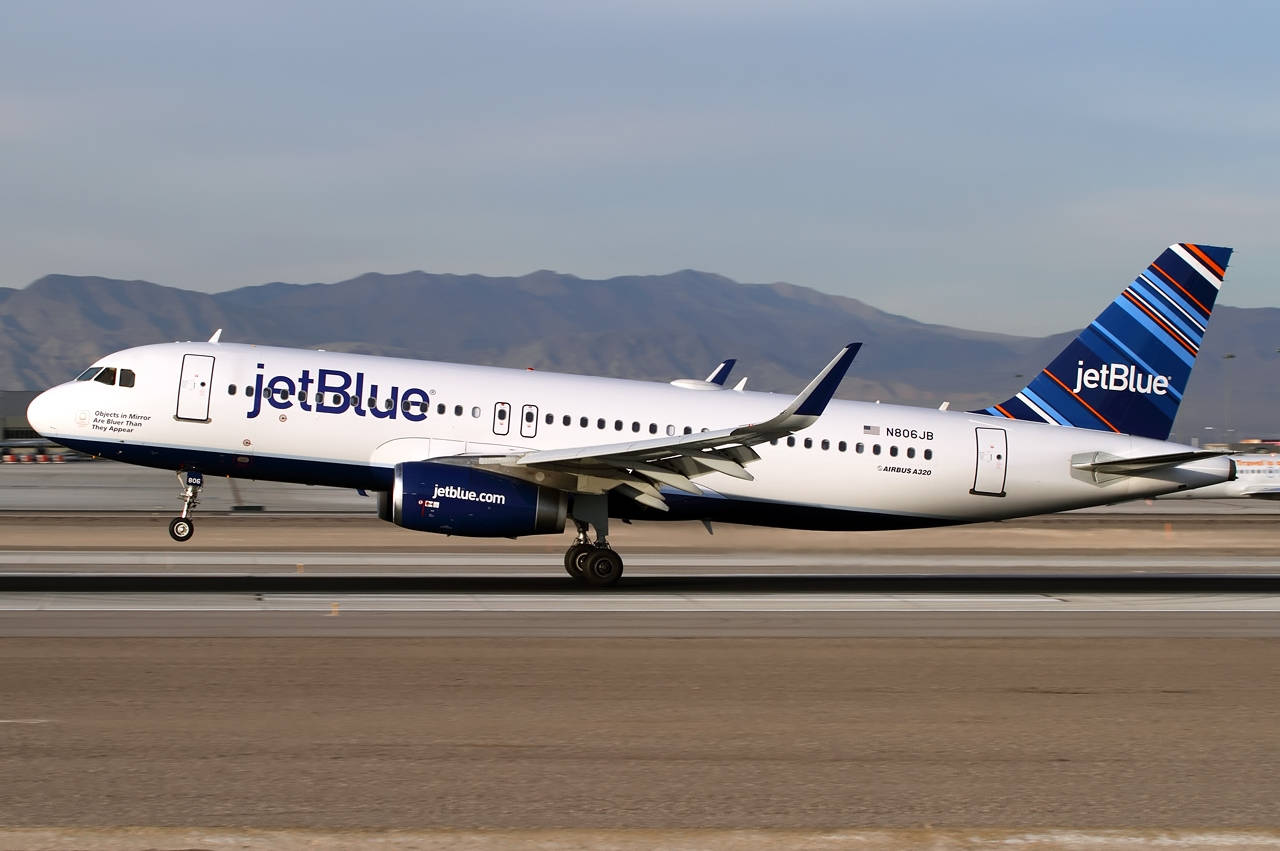 Jetblue Airways Plane On Airport Runway Background