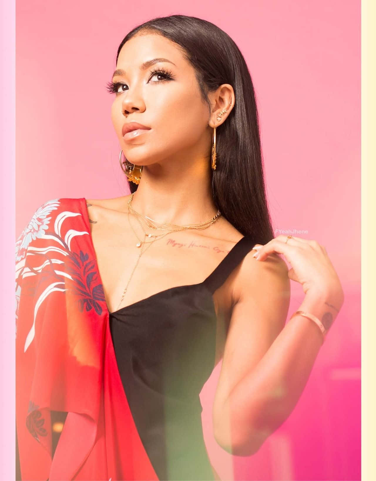 Jhene Aiko Striking A Pose Against A Vibrant Backdrop Background