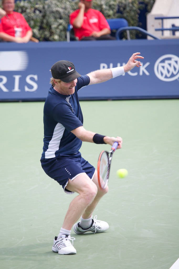 Jim Courier Displaying Expert Tennis Skills Background