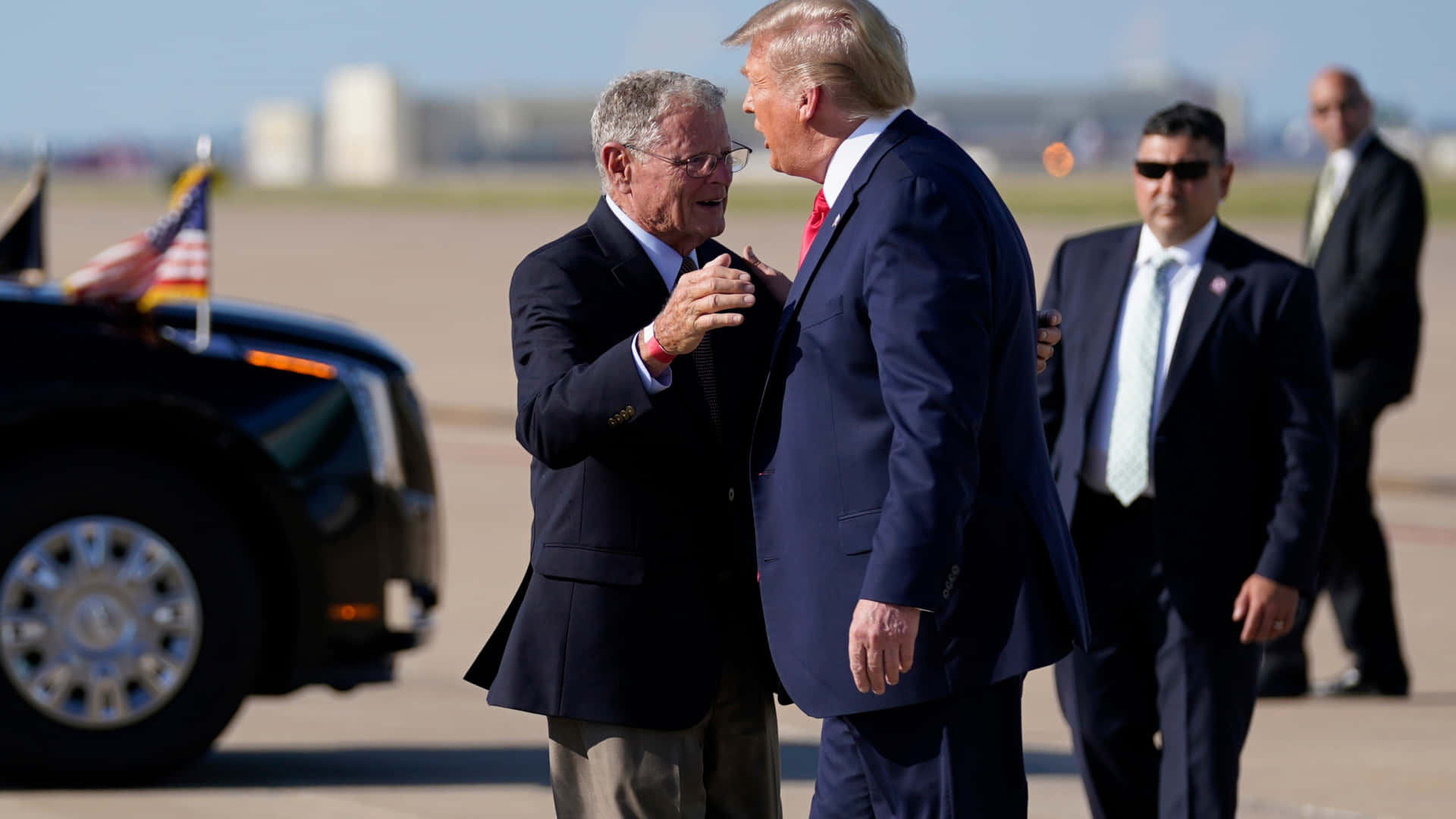 Jim Inhofe Hugging Trump At Airport Background