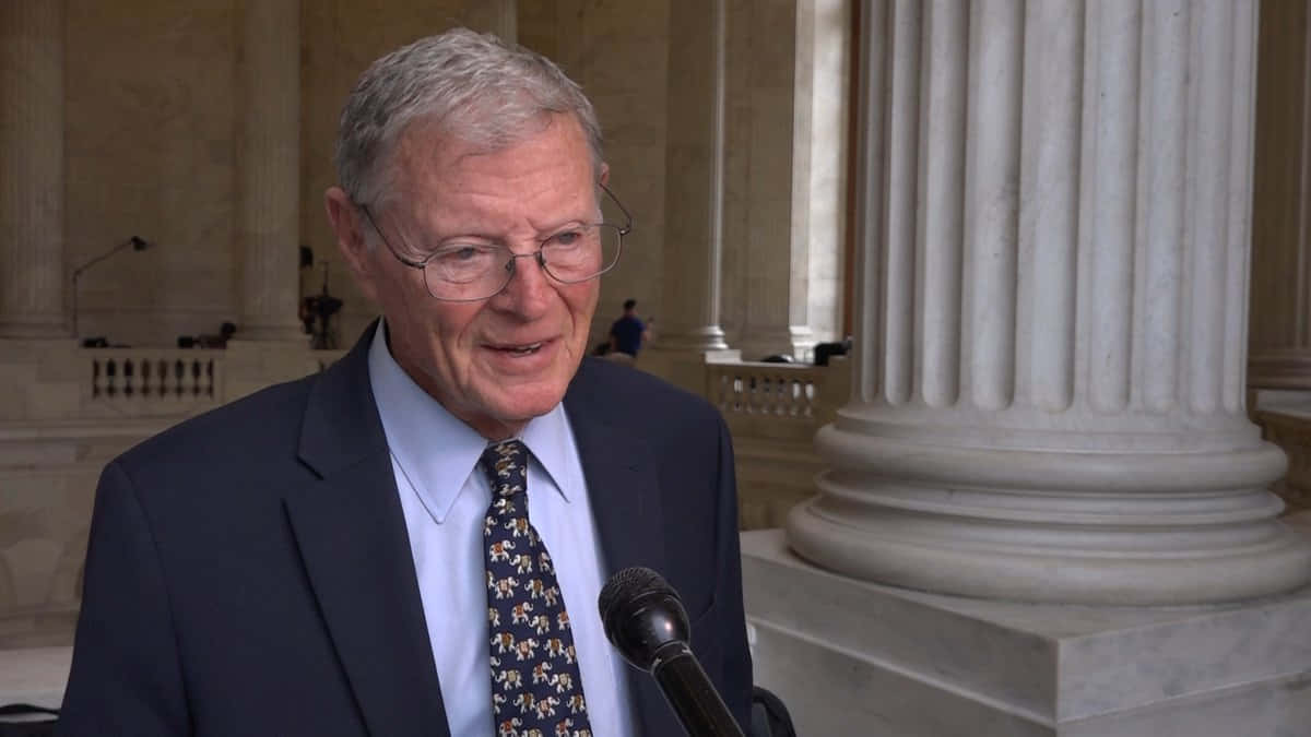 Jim Inhofe Speaking Into Microphone Background