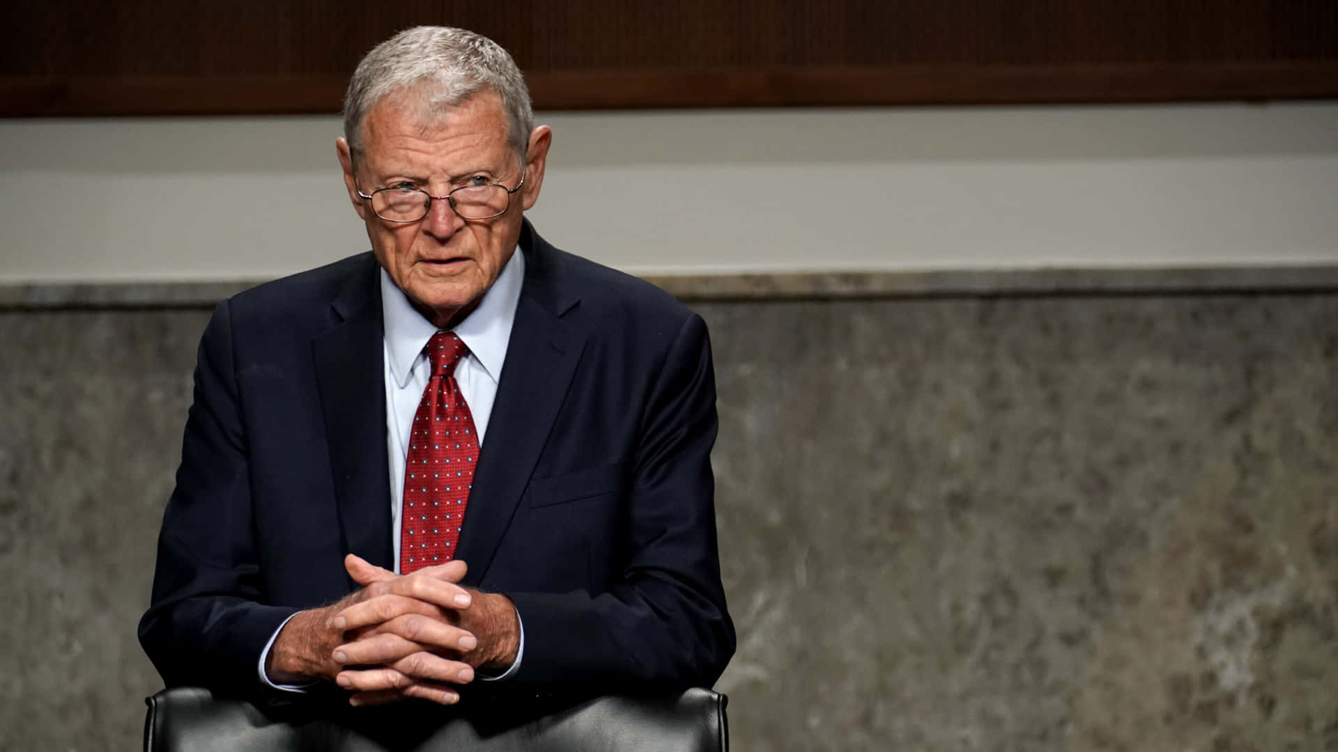 Jim Inhofe With Interlocked Fingers Background