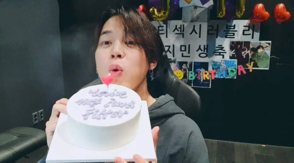 Jimin From Bts Blows A Cake Background