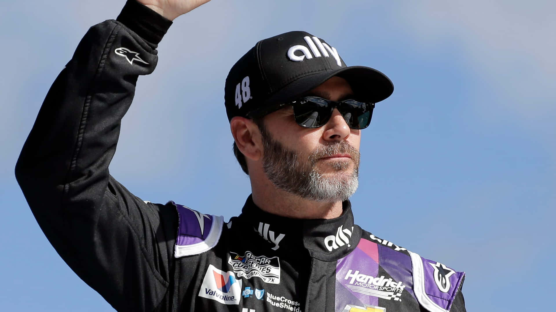 Jimmie Johnson Celebrating His Victory On The Racetrack Background