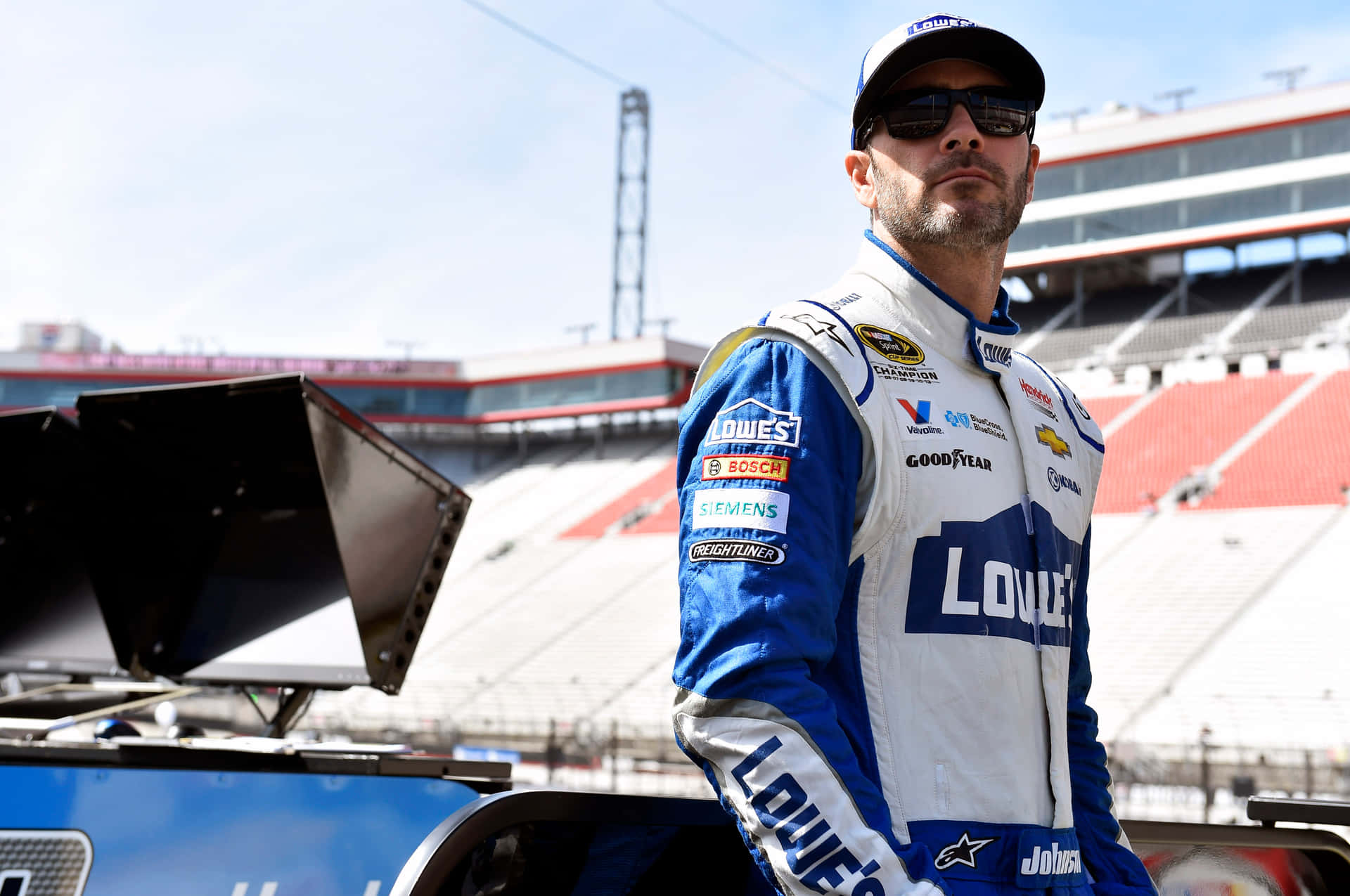 Jimmie Johnson Posing With His Nascar Race Car Background