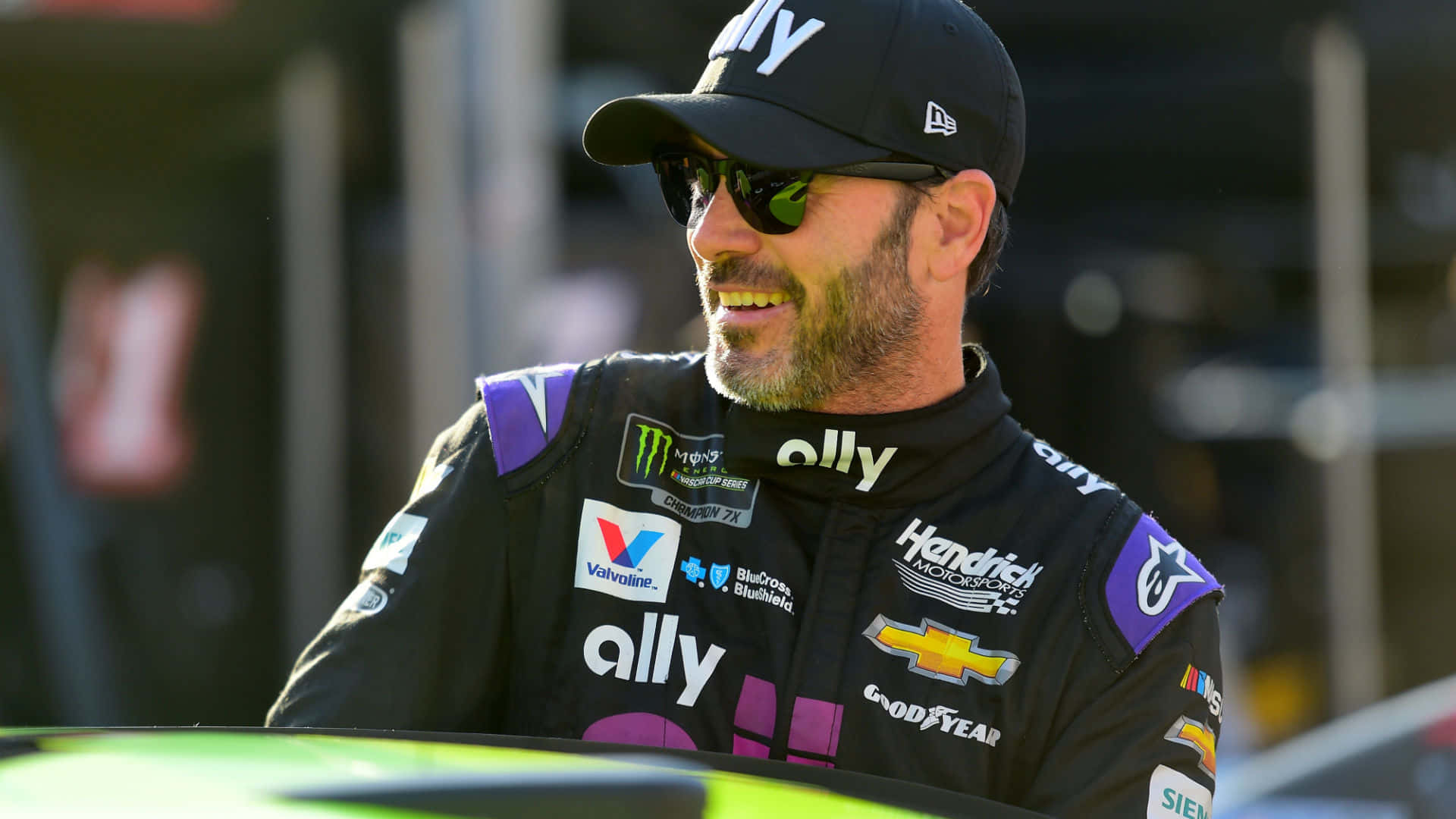 Jimmie Johnson Racing On The Track Background