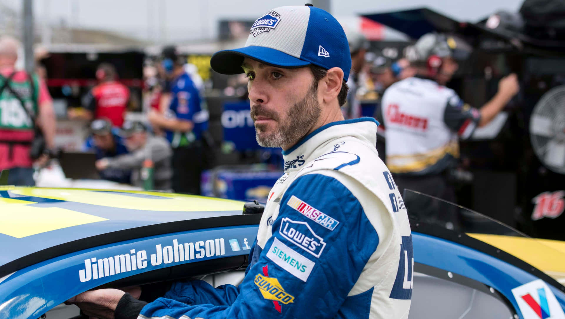 Jimmie Johnson Racing On The Track In His Iconic Car Background