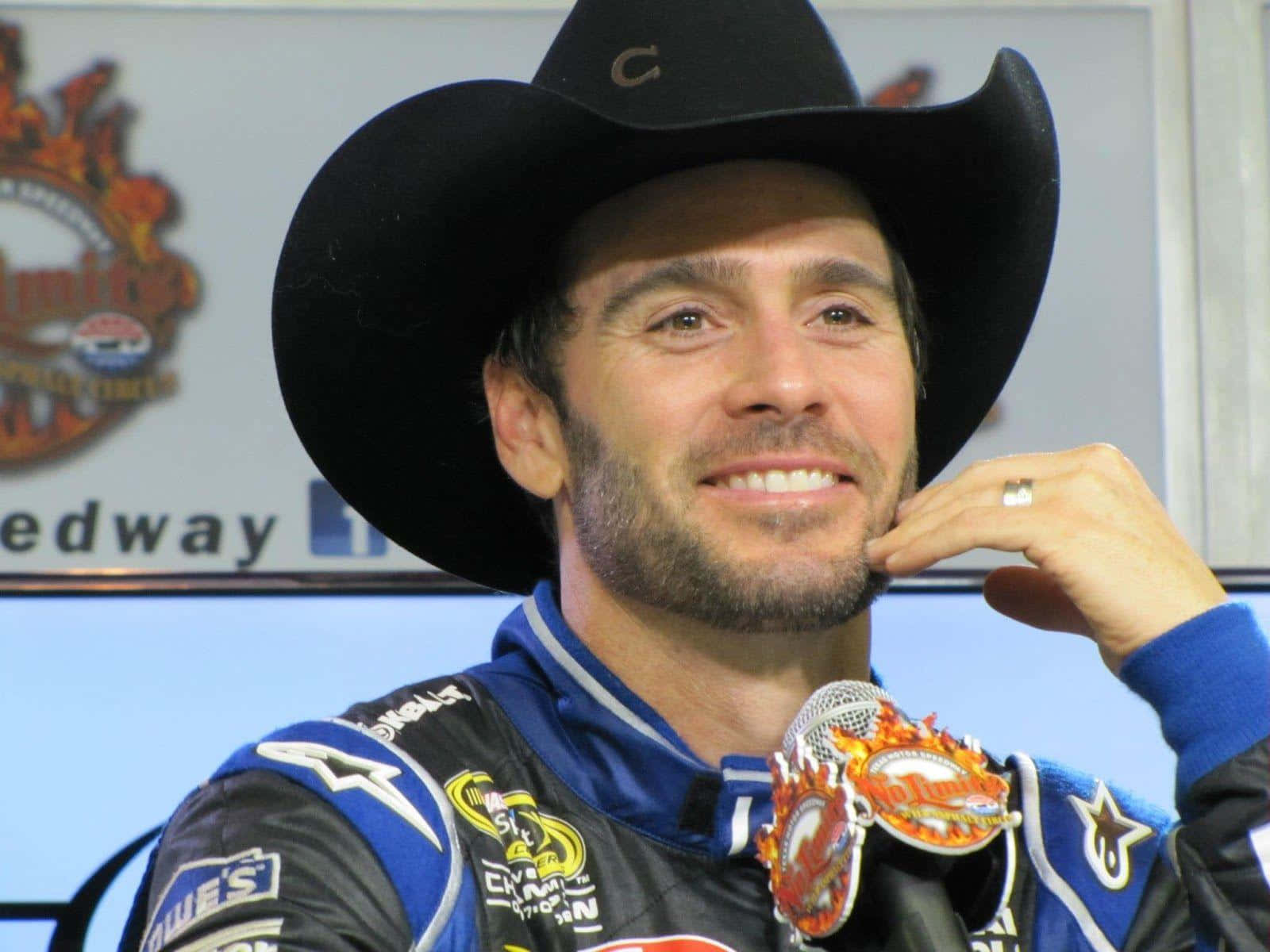 Jimmie Johnson Racing Toward Victory At A High-speed Nascar Event Background