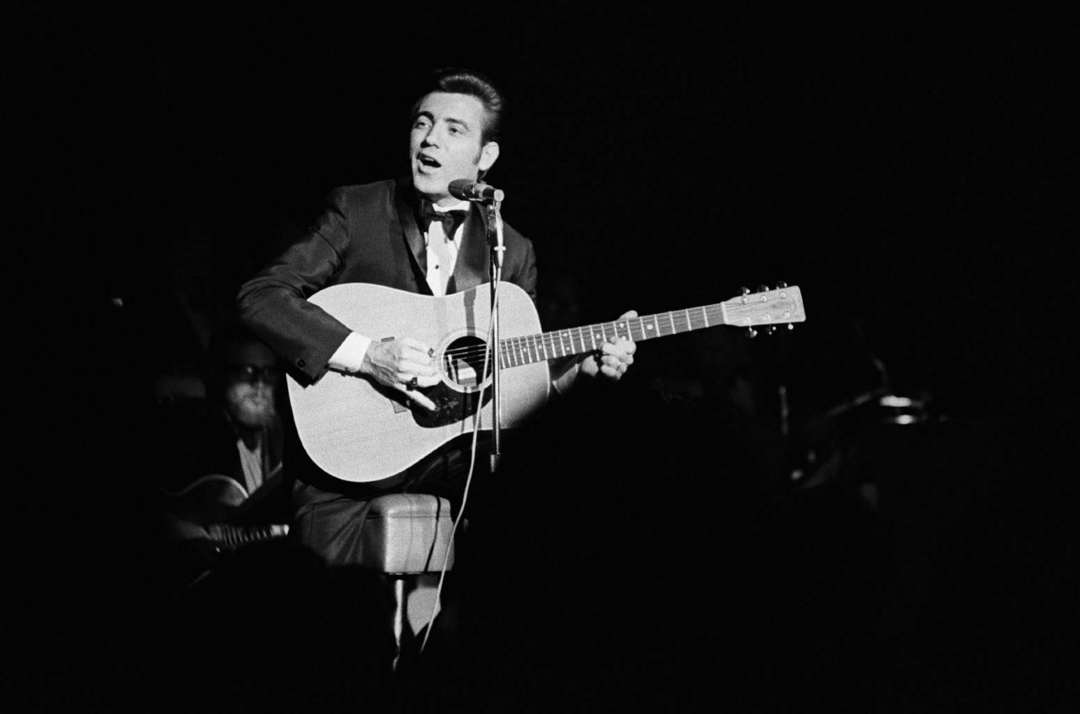 Jimmie Rodgers Performing On A Dark Stage