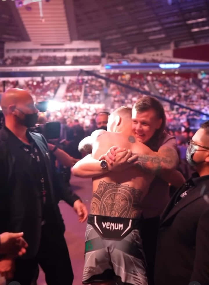 Jimmy Crute Hugging His Opponent Background