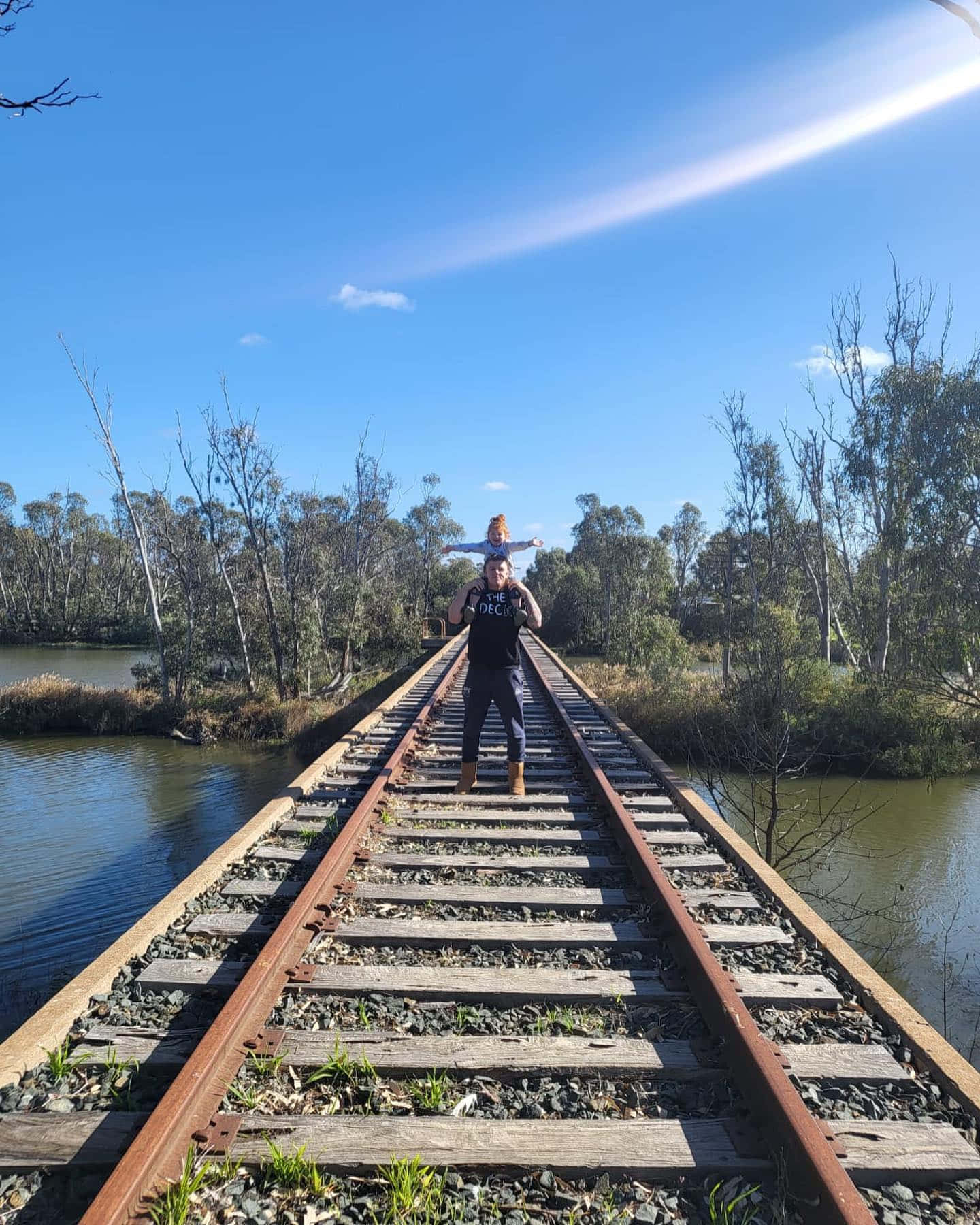 Jimmy Crute On Old Train Tracks With A Child Background