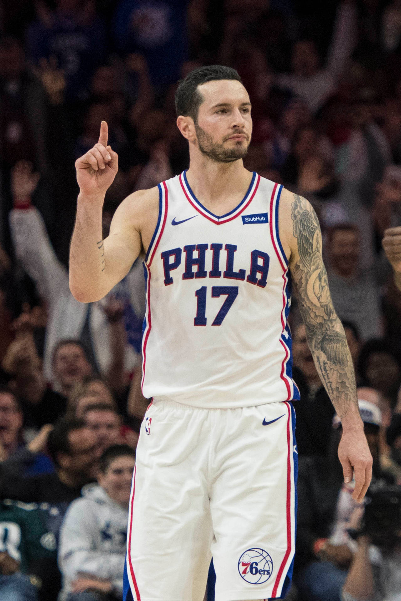 Jj Redick While Pointing Above Background