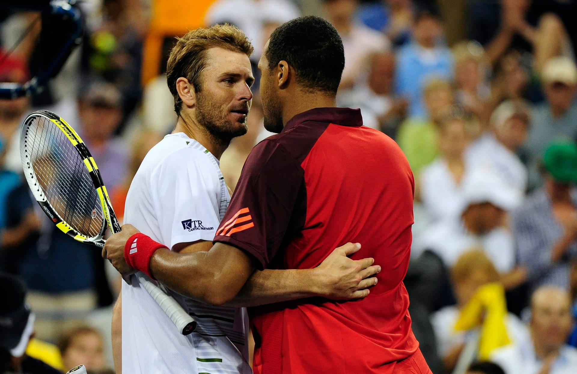 Jo-wilfried Tsonga Embracing His Opponent After A Tennis Match Background