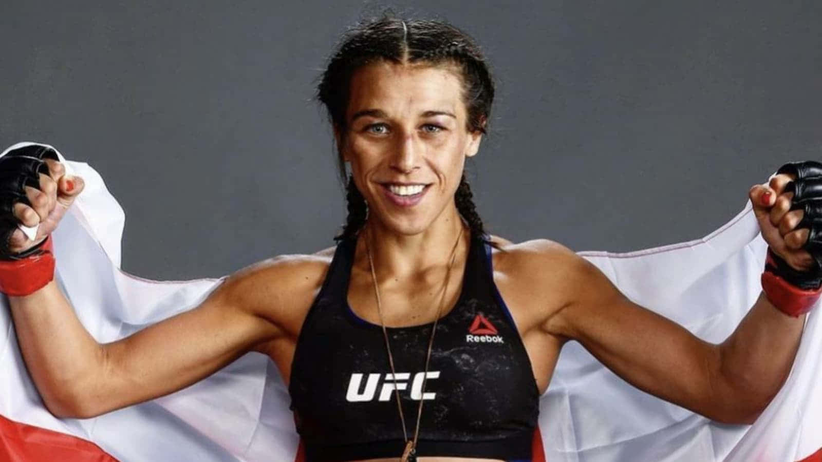 Joanna Jedrzejczyk Holding A Flag Background