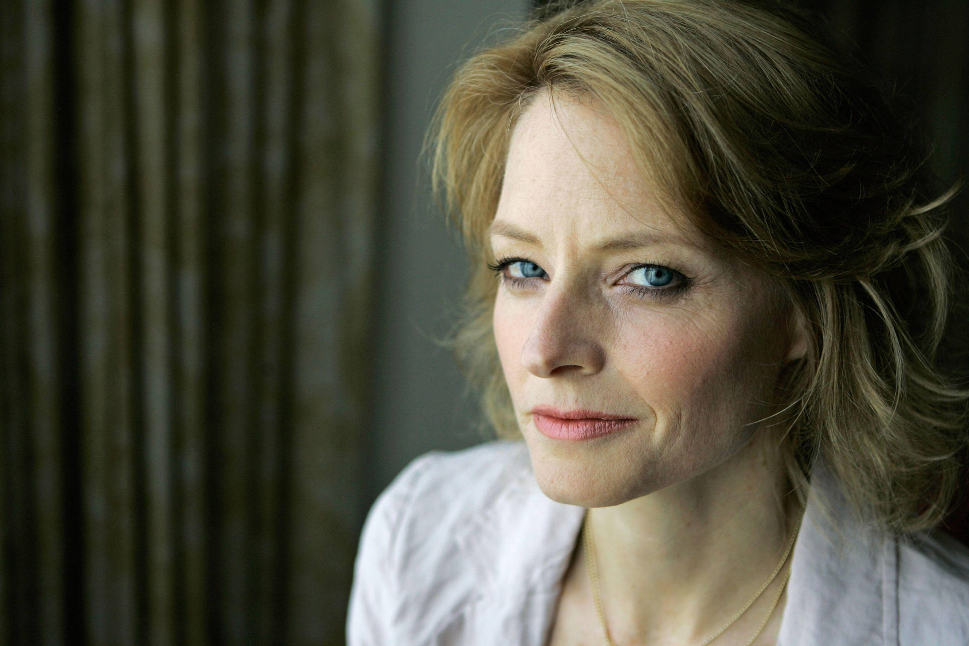 Jodie Foster's Contemplative Glance Background