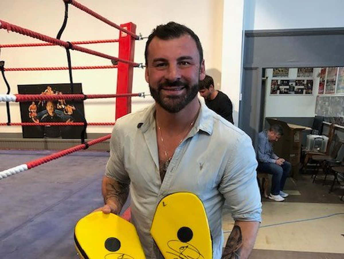 Joe Calzaghe Signing His Fan's Punching Mitts Background