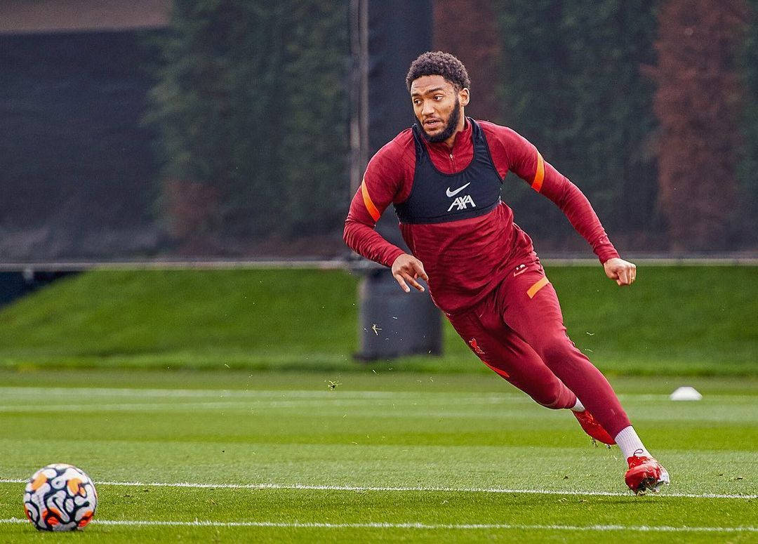 Joe Gomez Running After Ball Background