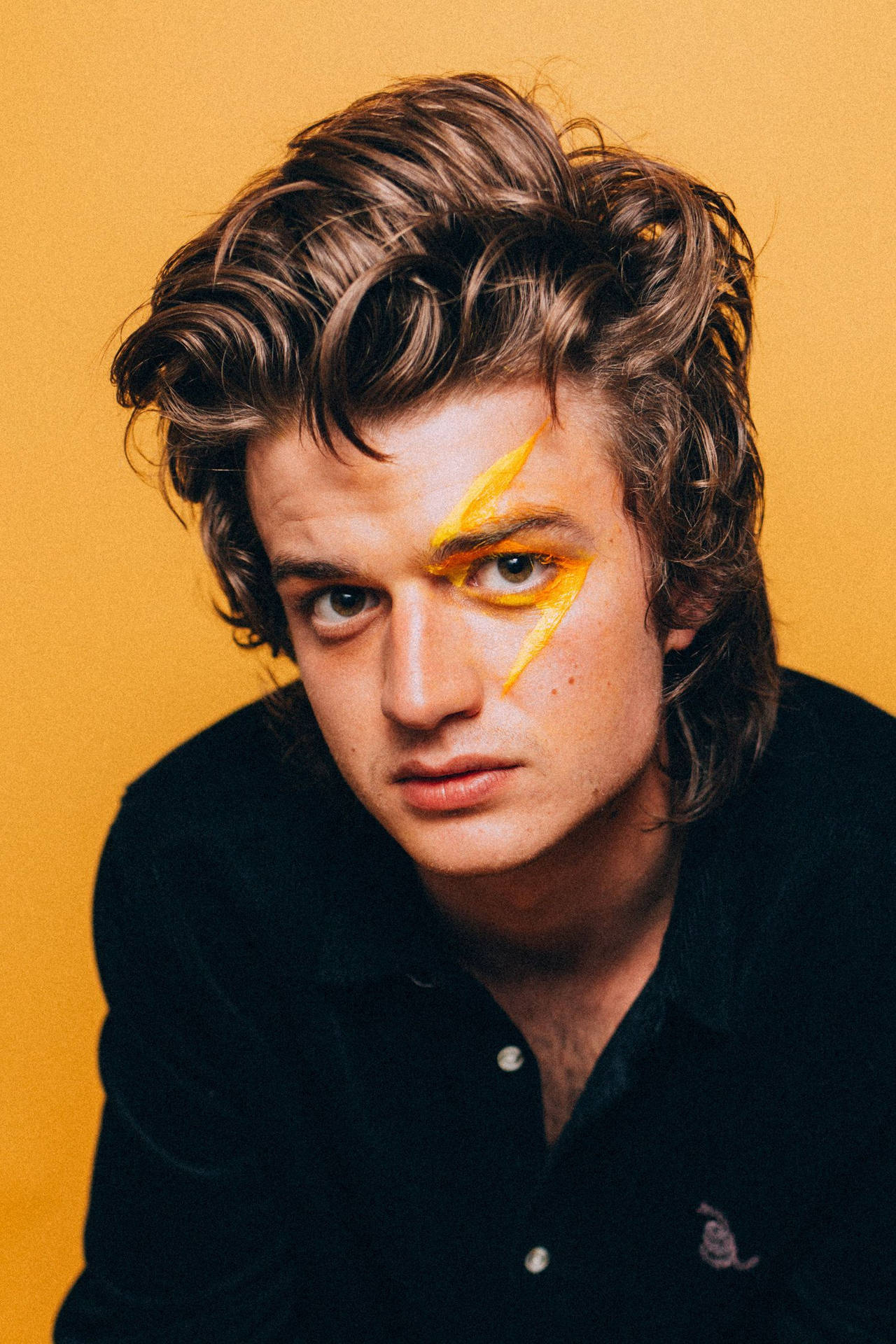 Joe Keery With Yellow Paint Background