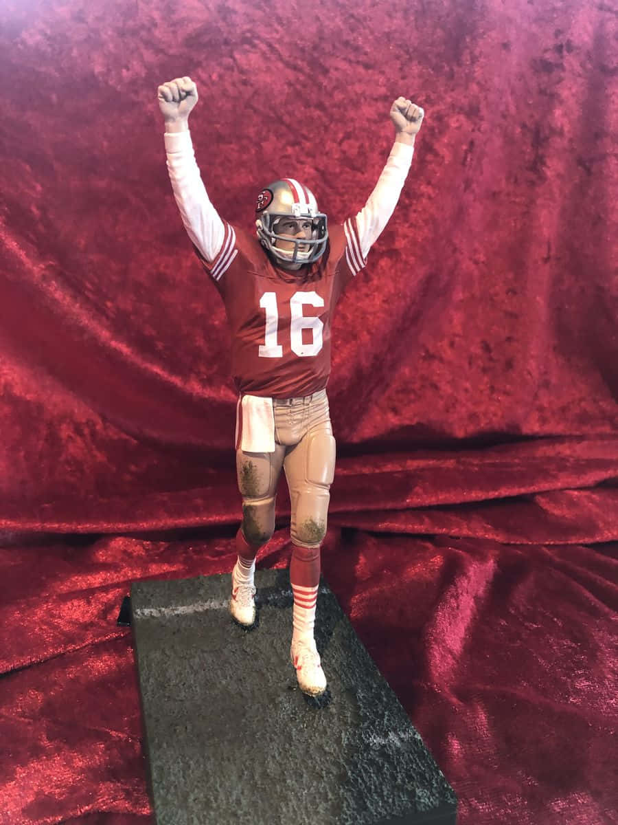 Joe Montana Stands Proudly With The San Francisco 49ers Background