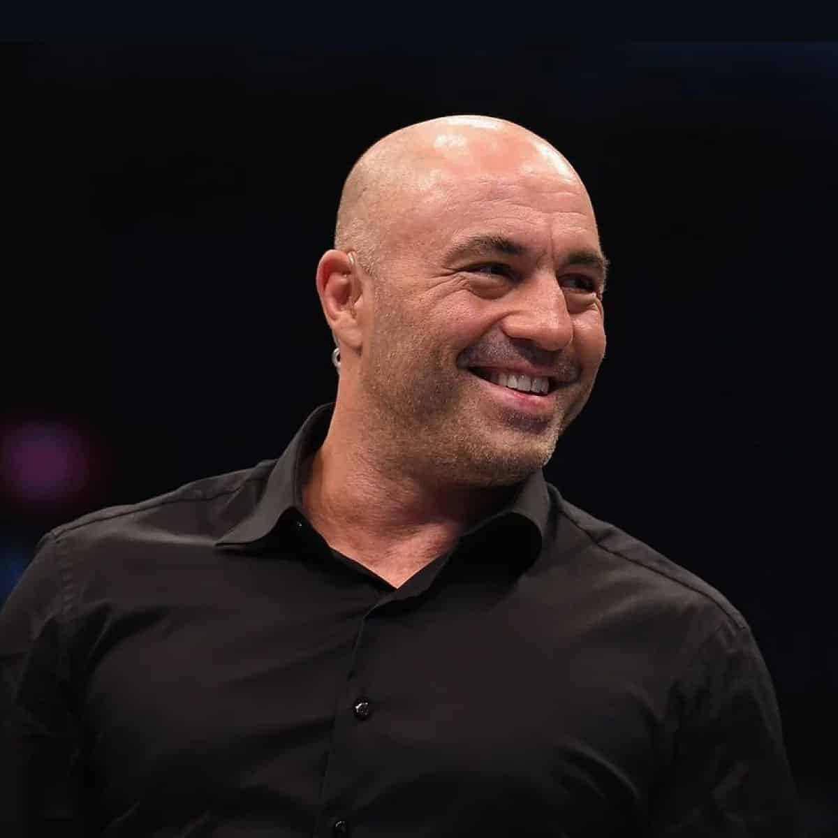 Joe Rogan Cracking A Joke Background