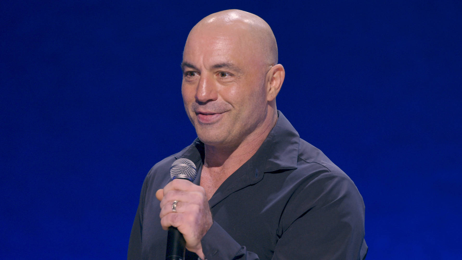 Joe Rogan Intensely Performing Stand-up Comedy Background