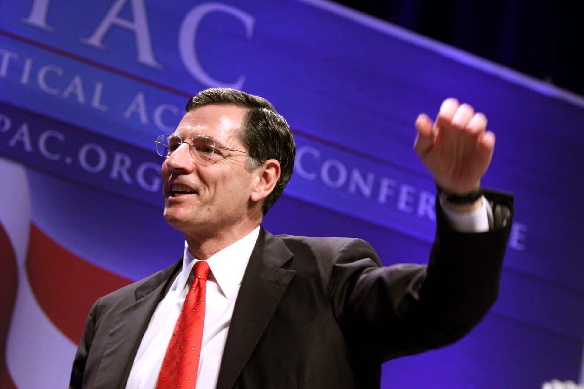 John Barrasso Raising Left Arm Background