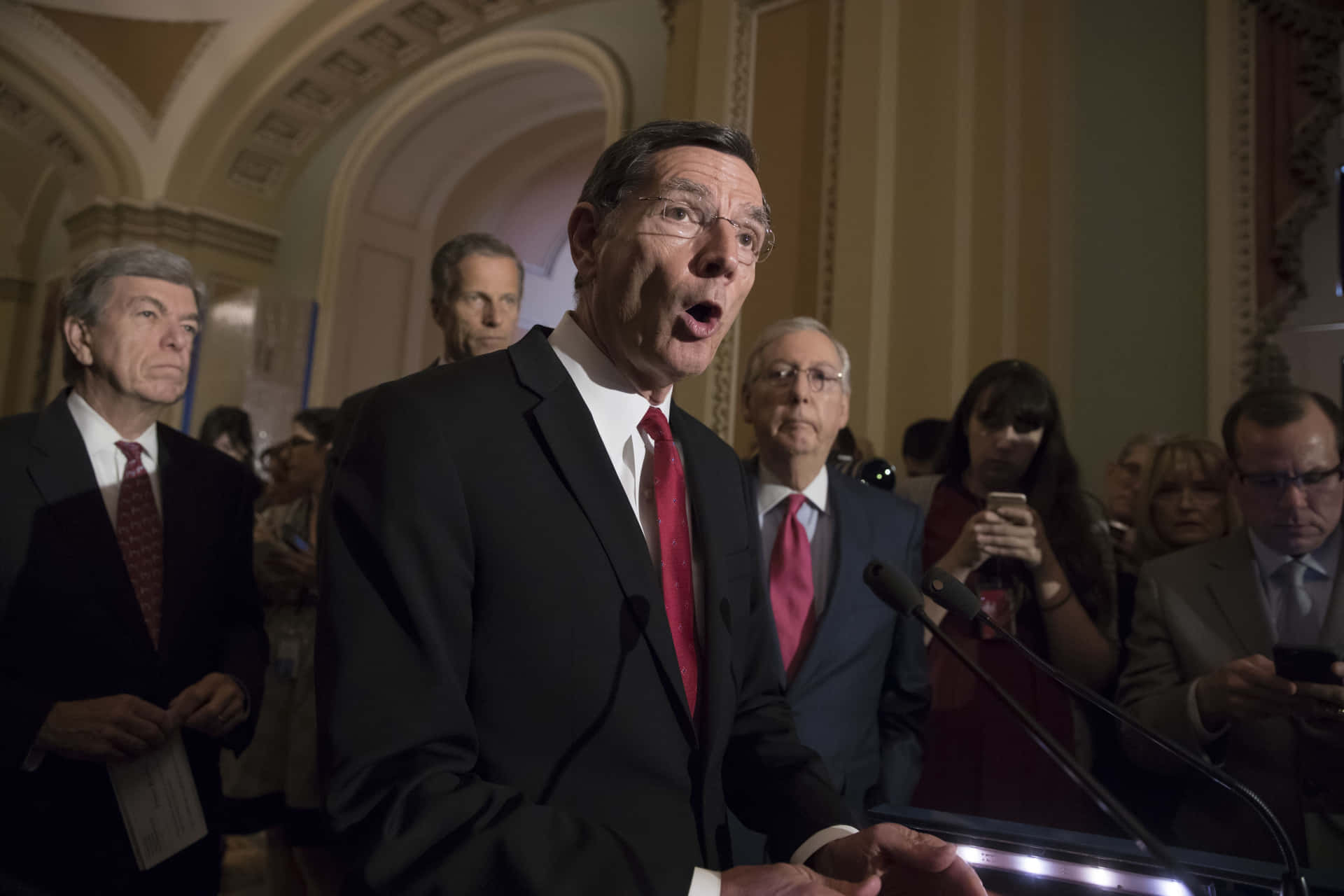 John Barrasso Speaking At Podium Background