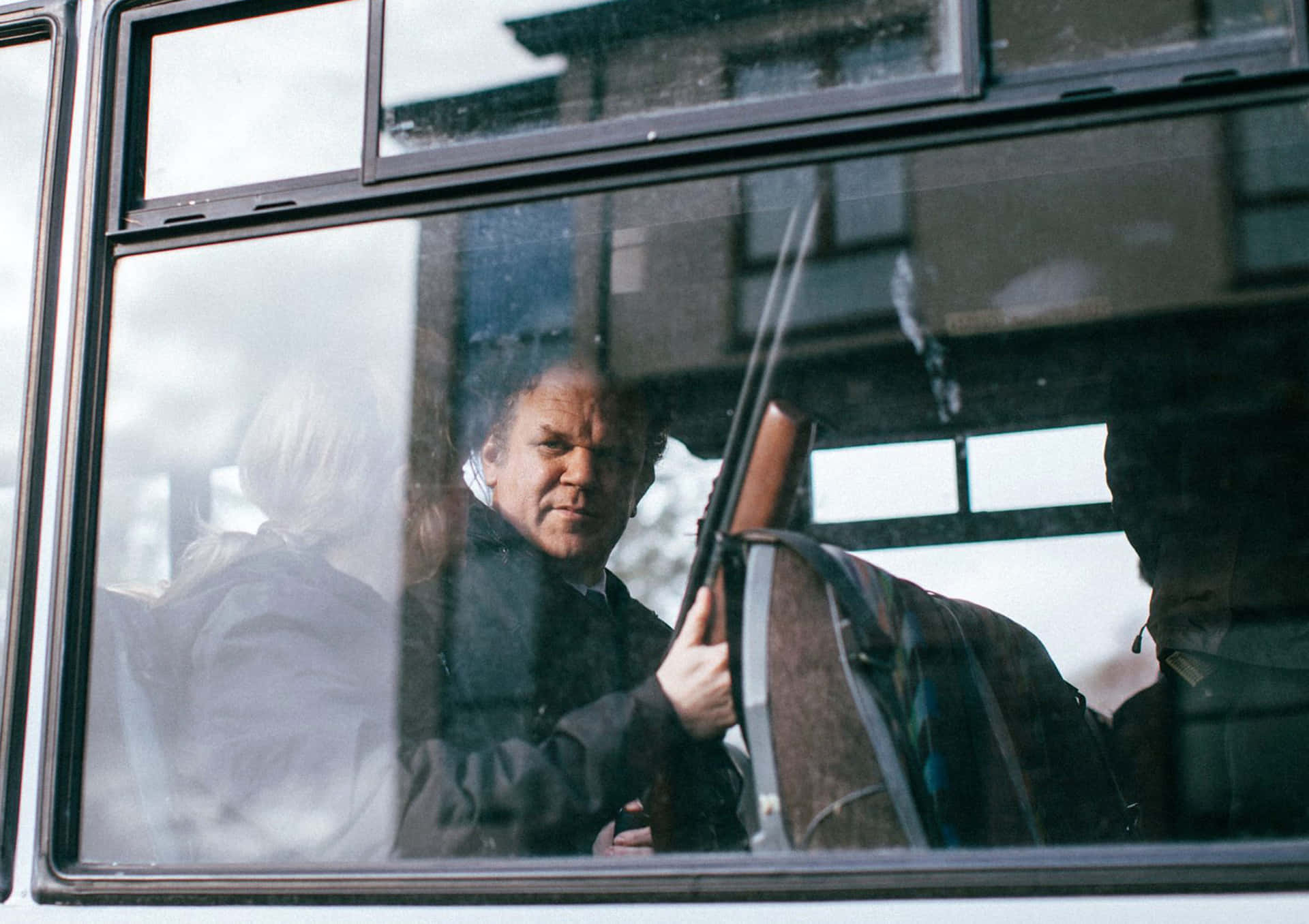 John C. Reilly Striking A Pose On A Photoshoot Background