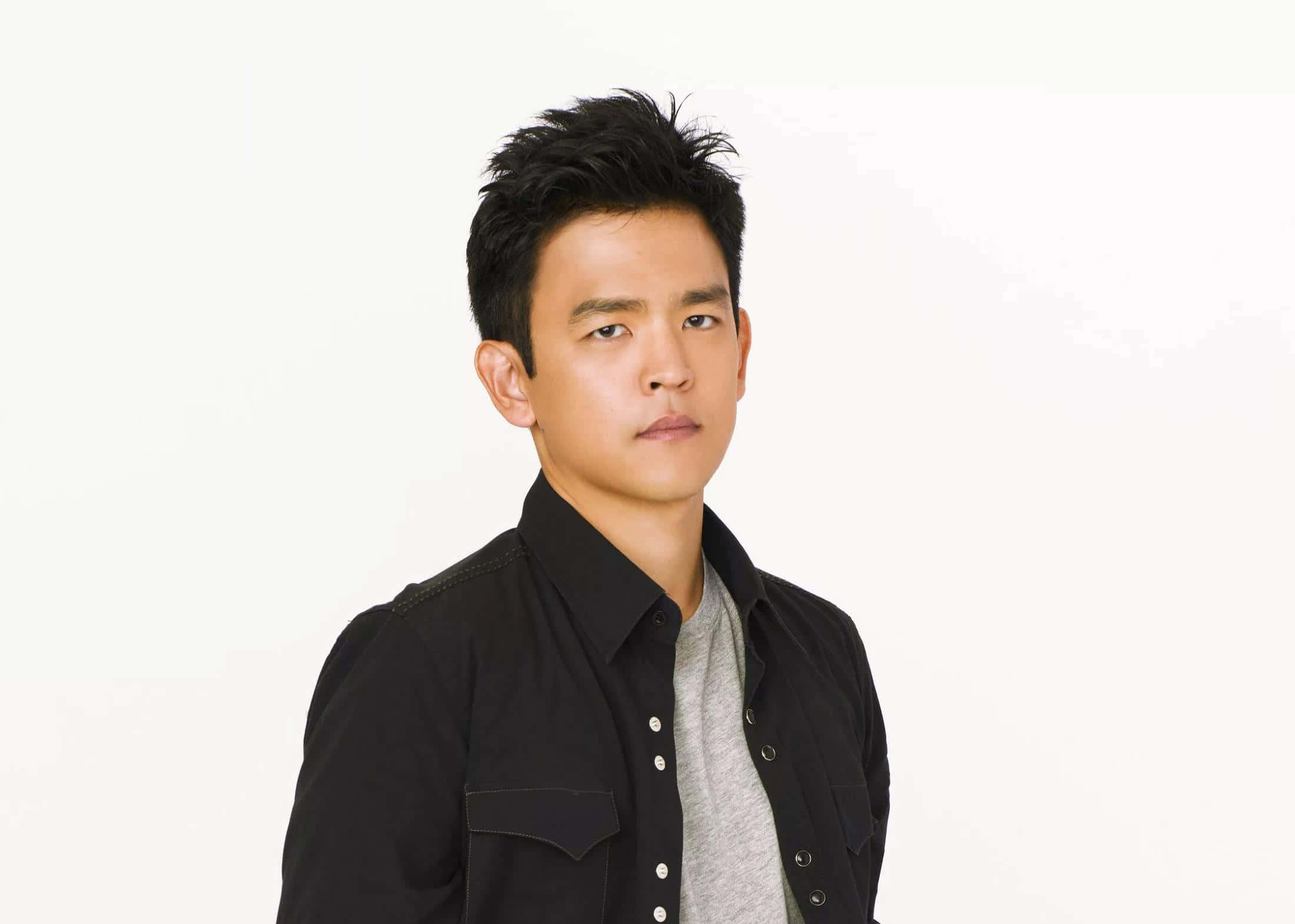 John Cho Striking A Pose In A Semi-formal Attire Background
