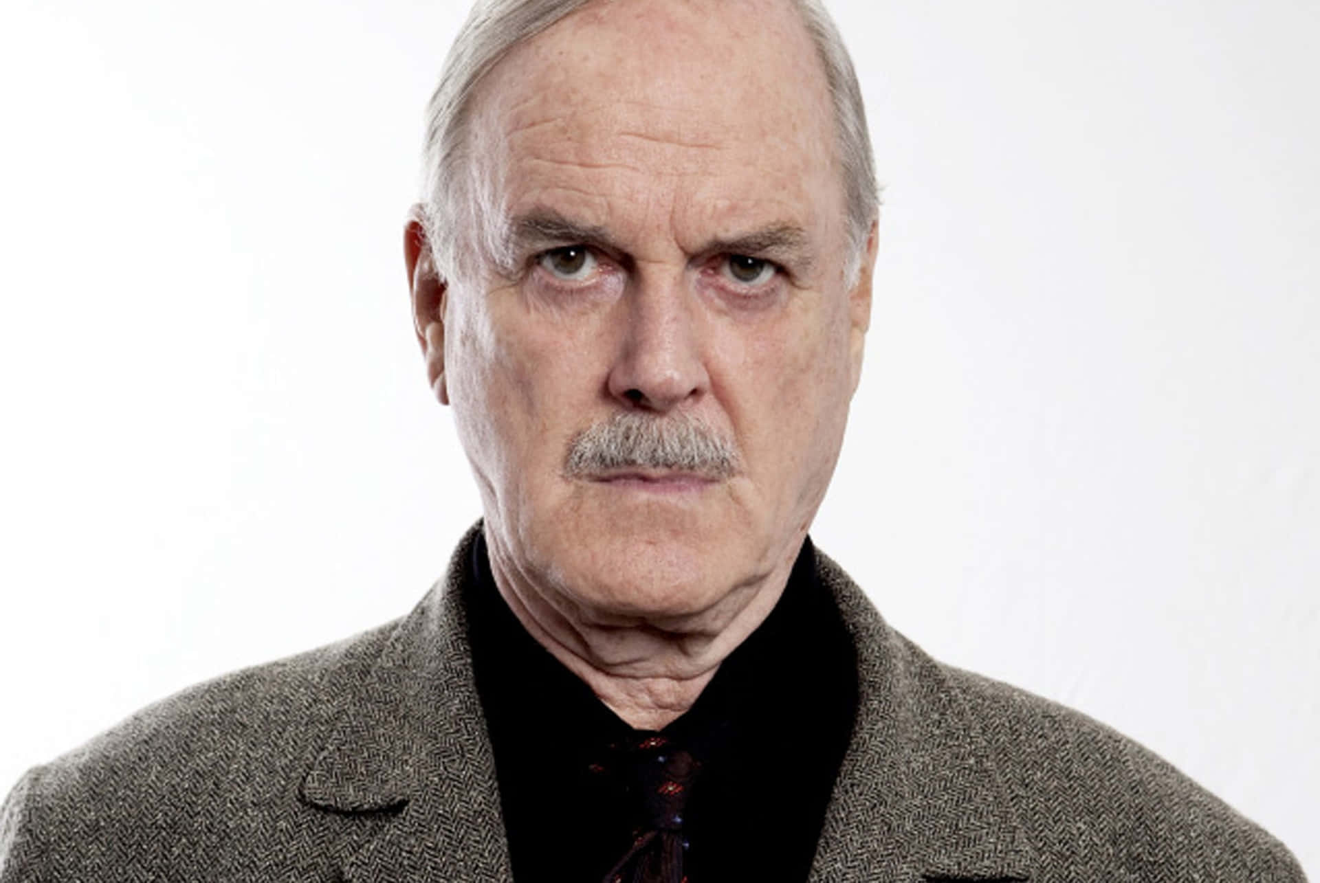 John Cleese In A Classic Comedic Pose. Background