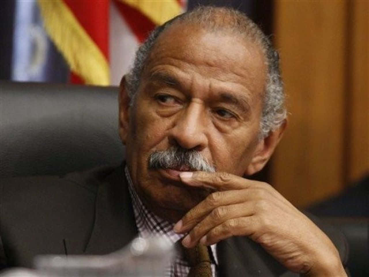 John Conyers Staunchly Delivering A Speech Background