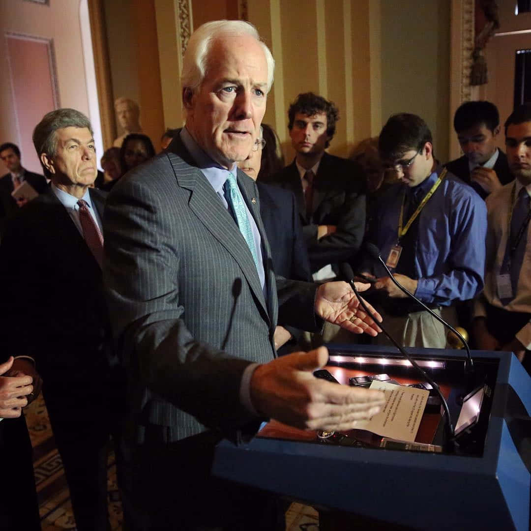 John Cornyn Being Surrounded By Reporters Background