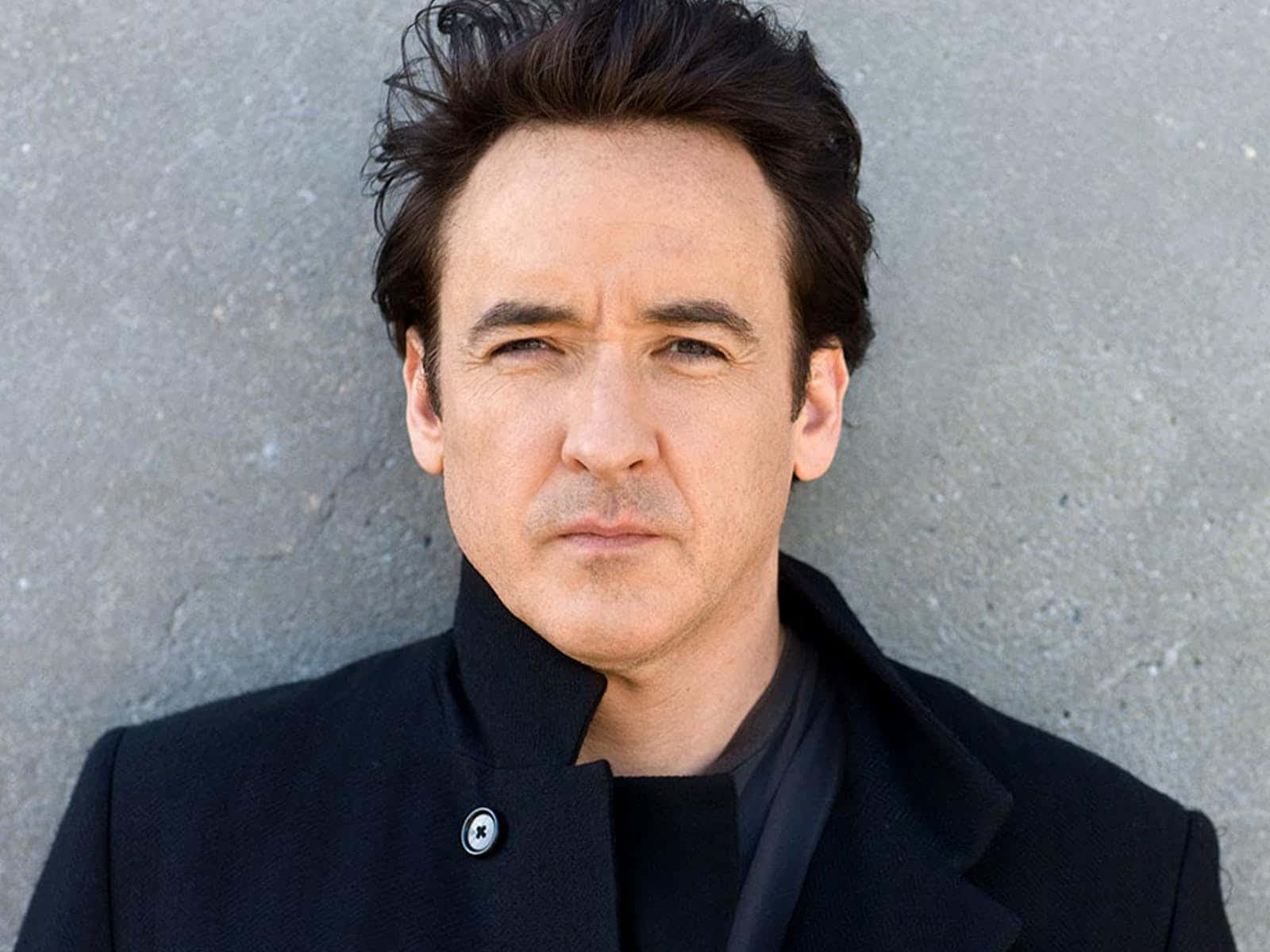 John Cusack Posing With A Confident Smile Background
