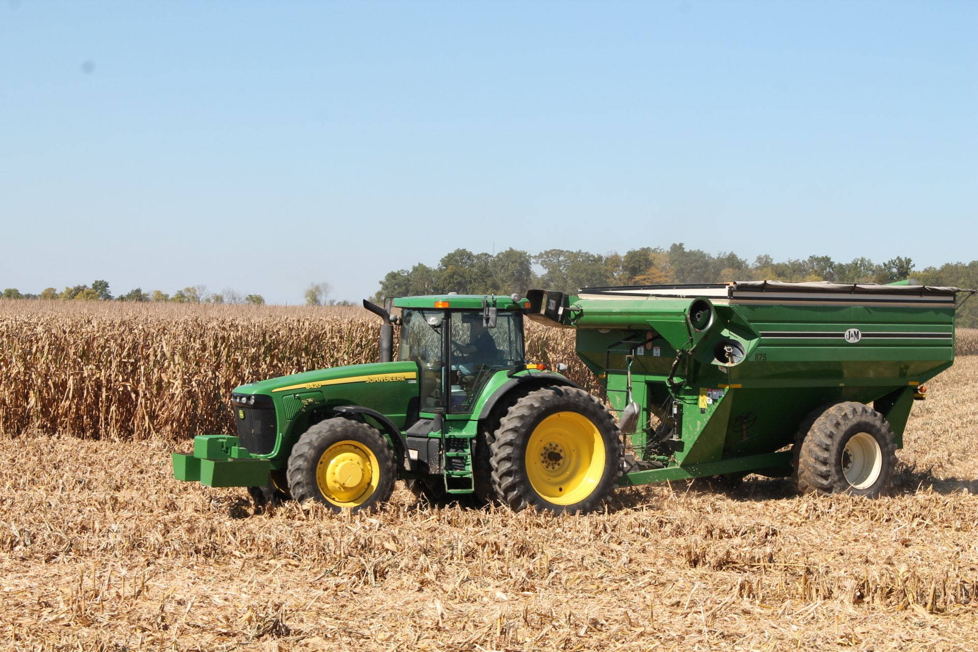 John Deere Tractor In Harvesting Wheat Background