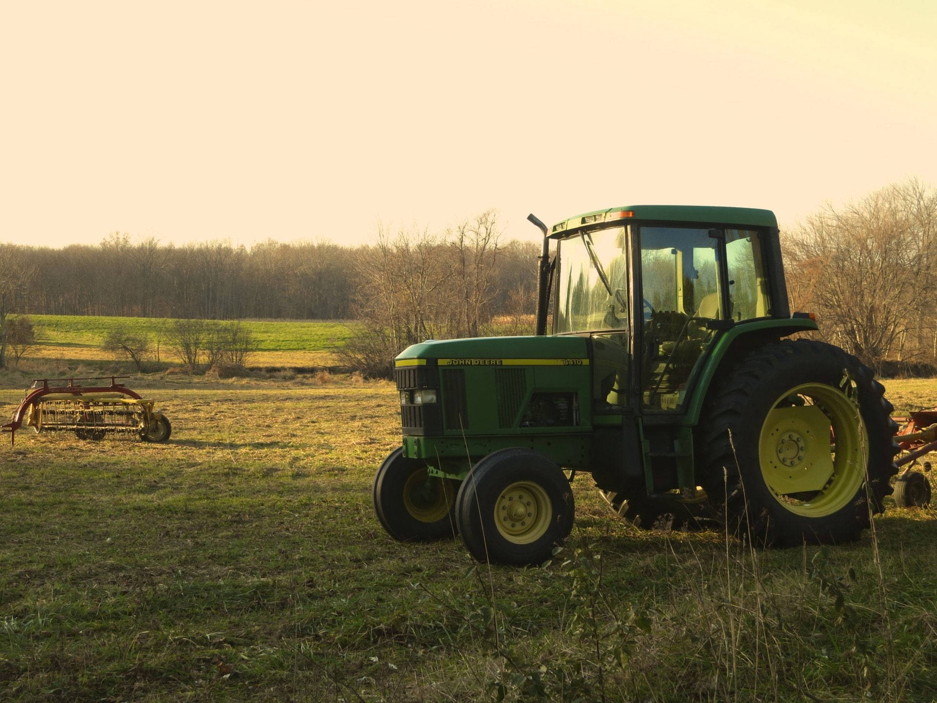 John Deere Tractor In Sunset Field Background