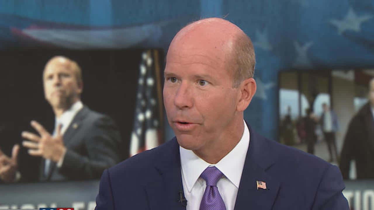 John Delaney Speaking At A Press Conference Background