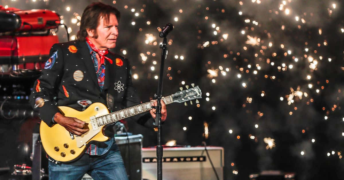 John Fogerty Performing Livewith Fireworks Background