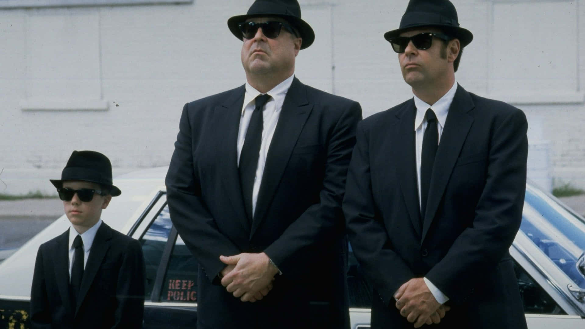 John Goodman Smiling In A Tuxedo Background