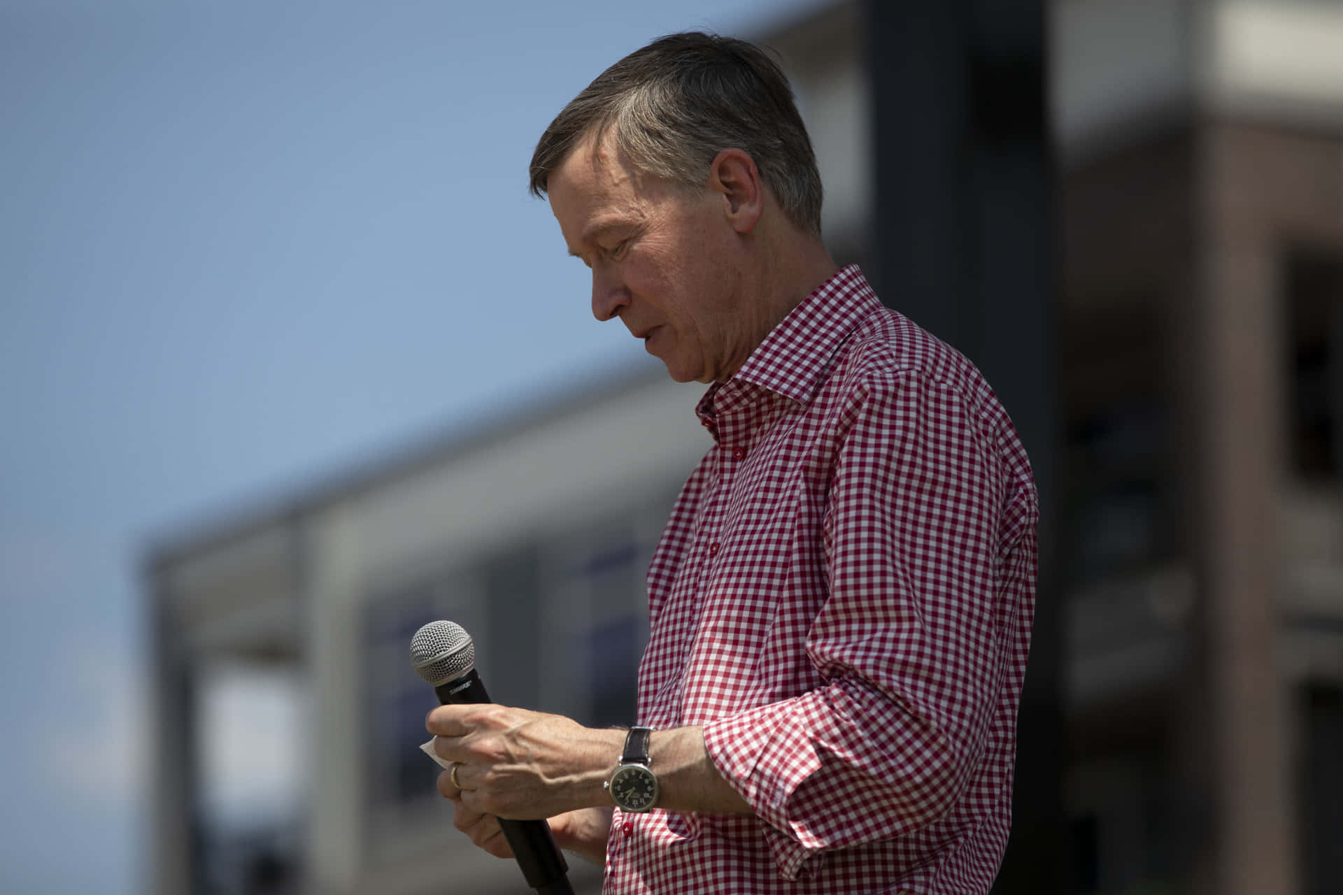 John Hickenlooper Addressing Audience With Microphone