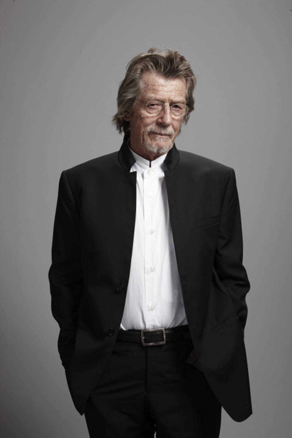 John Hurt Gray Background In Black Coat